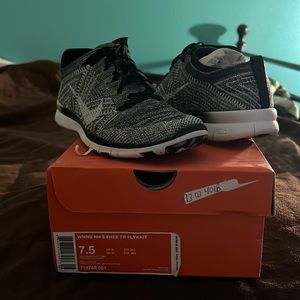 Women black and white Nike Free TR Flynit shoes